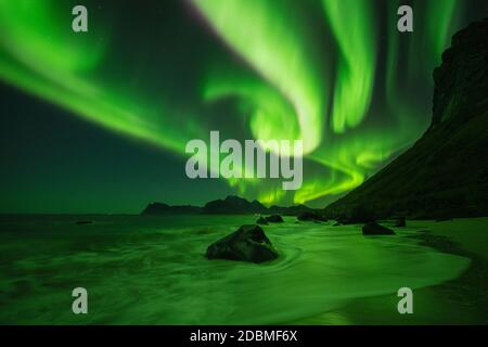 Aurora boreale - Aurora borealis splende nel cielo sulla spiaggia di Myrland, Flakstadøy, Isole Lofoten, Norvegia Foto Stock