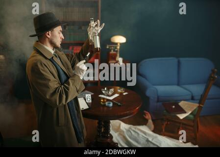 Il detective maschile prende le impronte digitali dalla bottiglia sulla scena del crimine, stile retrò. Investigazione criminale, ispettore sta lavorando su un omicidio, camera d'epoca Foto Stock
