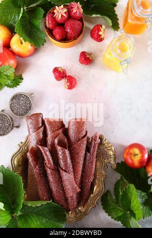 Berry pastille fatto di fragole e mele su uno sfondo bianco. Miele e semi di Cia su sfondo chiaro. Cibo per la salute. Copia spazio.la vista tra Foto Stock