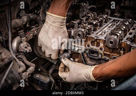 Meccanico automatico che lavora sul motore dell'automobile in garage meccanico Foto Stock