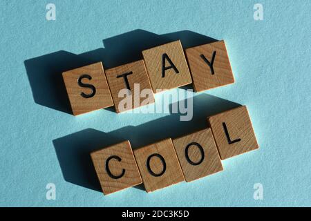 Resta fresco, parole in lettere alfabetiche in legno isolate su sfondo blu Foto Stock