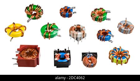 Vari induttori toroidali o trasformatori. Raccolta di bobine di induzione elettroniche con filo di rame avvolto su nucleo ferromagnetico. Elettrotecnica. Foto Stock