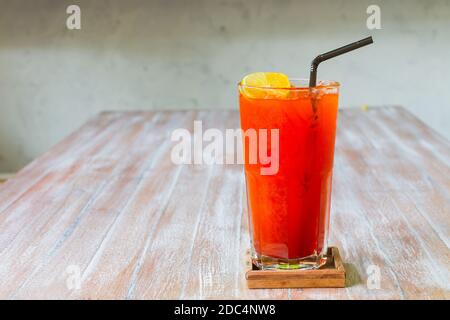 Bicchieri da tè ghiacciato con limone su sfondo tavolo di legno. Foto Stock