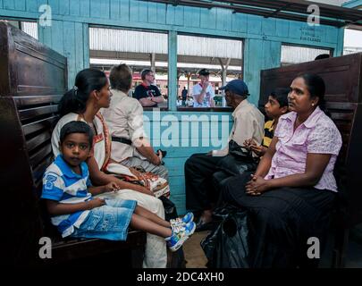 Turisti e locali Sri Lanka aspettano un treno per lasciare la stazione ferroviaria di Kandy. Kandy è la città più grande degli altopiani centrali dello Sri Lanka. Foto Stock