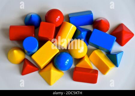 Vista aerea delle forme 3d in plastica in rosso, giallo e blu. Foto Stock