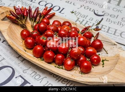 Pomodori ciliegini su un vassoio di legno Foto Stock