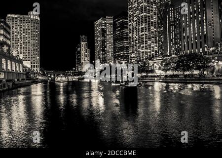 Grandi luci della città di notte lungo il fiume Foto Stock