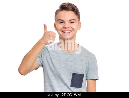 Cute teen boy che punta in su, gesturing idea o facendo il gesto numero uno. Foto Stock