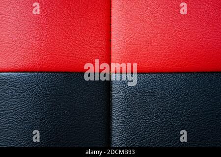La texture nera e rossa di pelle del divano può essere usata come sfondo Foto Stock