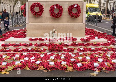 Il Cenotaph giù Whitehall coperto di corone papavero e la gente che paga il loro rispetto. Londra Foto Stock