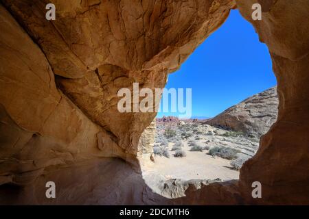 Guardando attraverso il deserto del Nevada da Small Cave in Valley of Parco nazionale dei vigili del fuoco Foto Stock