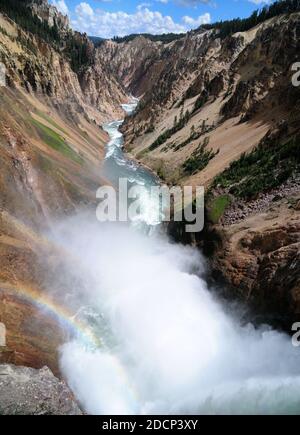 Vista su Mist del fiume Yellowstone dal Brink Di Lower Falls Viewpoint in UNA giornata estiva di sole con Un cielo azzurro e alcune nuvole Foto Stock