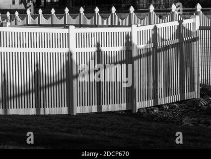 Vista in bianco e nero di recinzione e ombre in stile picket in vinile bianco; Salida; Colorado; USA Foto Stock