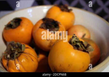 Frutta di persimmon in ciotola Foto Stock