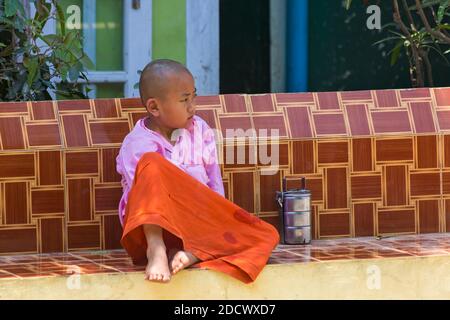 Giovane novizio nun seduto al posto di Aung Myae Oo Monastico Free Education School, Sagaing, Mandalay, Myanmar (Birmania), Asia nel mese di febbraio Foto Stock