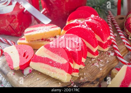 Biscotti fatti in casa alla menta piperita, salame di cioccolato in velluto bianco e rosso con biscotti e nocciole. Dolci natalizi in stile caramella Foto Stock