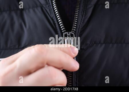 Chiusura a zip manuale maschio su rivestimento nero Foto Stock