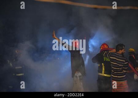 Dhaka, Dhaka, Bangladesh. 24 Nov 2020. I vigili del fuoco e la popolazione locale lavorano per estinguere un incendio in una baraccopoli di Mohakhali Sattola a Dhaka, Bangladesh, il 24 novembre 2020. Credit: Zabed Hasnain Chowdhury/ZUMA Wire/Alamy Live News Foto Stock