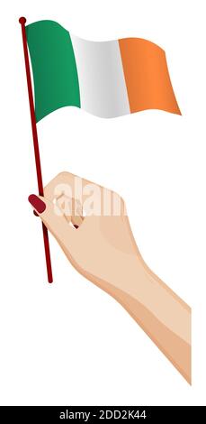 La mano femminile tiene delicatamente una piccola bandiera dell'irlanda. Elemento di design per le vacanze. Vettore cartoon su sfondo bianco Illustrazione Vettoriale