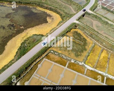 Guerande (Francia nord-occidentale): Veduta aerea delle paludi saline. Automobili viste dall'alto su piccole strade tra le paludi saline Foto Stock