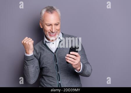 Ritratto del suo bel banchiere allegro allegro e allegro squalo da lavoro che indossa un abbigliamento formale e informale utilizzando la connessione cellulare veloce isolato Foto Stock