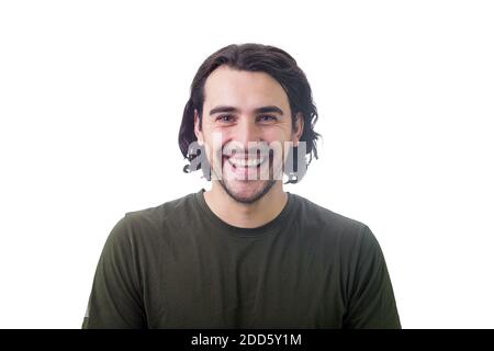 Ritratto di giovane bruna sorridente, capelli lunghi ricci, che guarda gioioso e ridendo a macchina fotografica isolata su sfondo bianco. Allegro e succhia Foto Stock