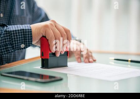 Uomo che stampano il tampone su contratto Foto Stock