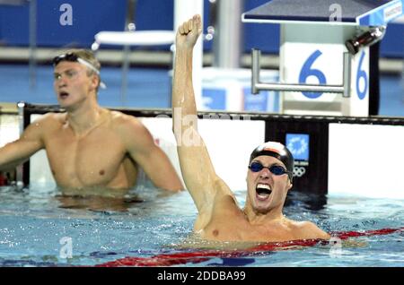NESSUN FILM, NESSUN VIDEO, NESSUNA TV, NESSUN DOCUMENTARIO - Pieter van den Hoogenband dei Paesi Bassi reagisce alla sua medaglia d'oro vincendo la performance nelle finali della gara maschile di 100m freestyle mercoledì 18 agosto 2004 al Centro Acquatico Olimpico di Atene. A sinistra si trova Andrey Kapralov, russo. Foto di David Foto Stock