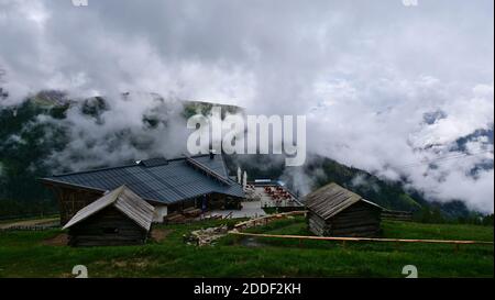 Obertilliach, Austria - 06-19-2020: Vista su Conny Alm, ristorante con terrazza, vicino alla stazione di montagna della funivia Golzentipp in popolare stazione sciistica. Foto Stock