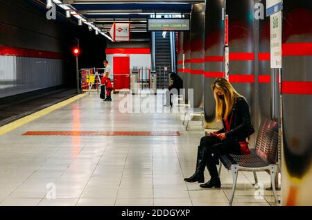 Madrid, Spagna 21 novembre 2020: Le persone che indossano maschere facciali aspettano un tarain su una piattaforma vicina vuota della stazione di Madrid Foto Stock