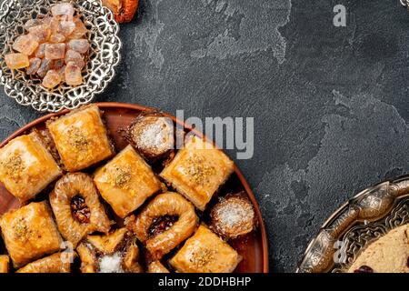 Assortimento di baklava turca su superficie ruvida nera Foto Stock