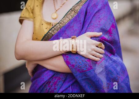 Giovane donna europea con capelli corti in viola tradizionale saree. Ritratto esterno in luce solare tenue. India, Bangalore, primo piano Foto Stock