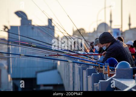 Persone e pescatori che pescano sul Ponte di Galata durante i giorni della pandemia del coronavirus. Il Ponte Galata è un ponte che attraversa il Corno d'Oro. Foto Stock