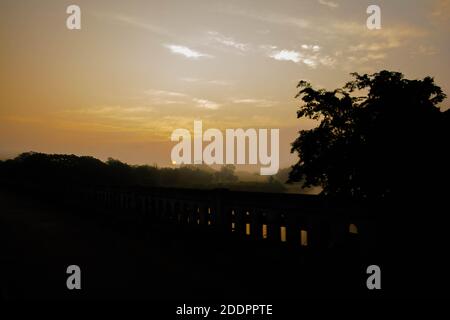 Paesaggio di montagne, alberi e nebbia nel periodo dell'alba al parco nazionale di Kaziranga, Assam, India. Foto Stock