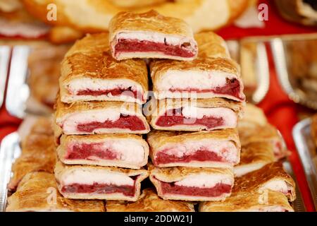 Strudel fatti in casa con vari sapori in vendita al mercato di natale all'aperto. Torte fresche fatte in casa farcite con vari ripieni. Serve natu nazionale Foto Stock