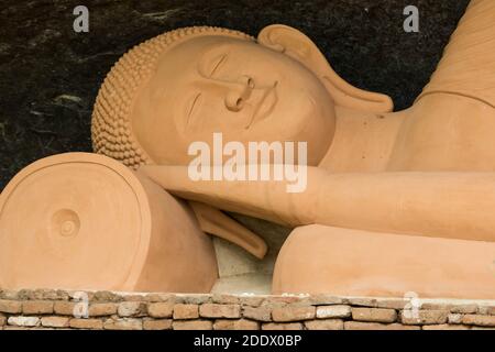 Statua di Buddha reclinata al tempio di Tharulengala Hulannuge Foto Stock