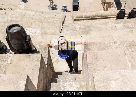 Una donna turistica cinese nell'antico anfiteatro romano di Amman, Giordania Foto Stock