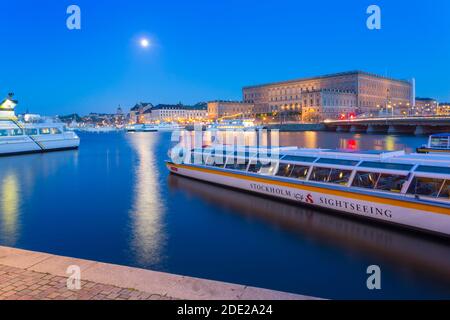 Il Palazzo reale e le barche turistiche al crepuscolo, Stoccolma, Svezia, Scandinavia, Europa Foto Stock