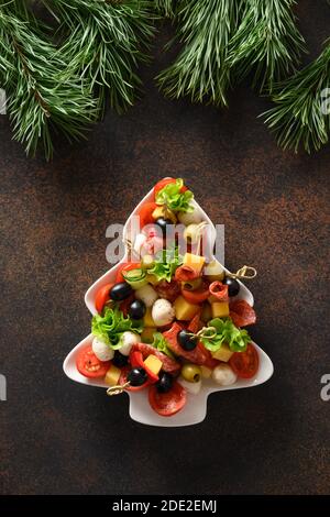 Spuntini di festa come canapes a forma di piatto di albero di Natale per festa di Natale. Vista dall'alto. Foto Stock