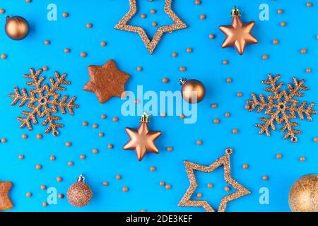 Flatlay di fiocchi di neve decorativi in argento e oro, stelle e palline su sfondo blu che può essere utilizzato come copertura del biglietto d'auguri di Natale Foto Stock