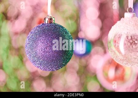 Decorazioni sferiche blu ricoperte di minuscoli luccichini d'argento e altro Palline decorative appese davanti alla fotocamera nel colorito Natale sfondo Foto Stock