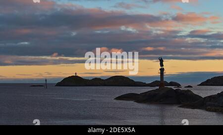 Svolvær, Austvågøya, Lofoten, Norvegia - 08-26-2020: Tranquilla vista serale della costa di fronte al porto di Svolvaer con scultura Fiskerkona. Foto Stock