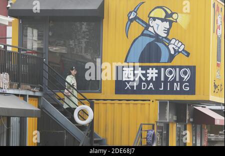 (201129) -- JIAOZUO, 29 novembre 2020 (Xinhua) -- UN turista visita una strada commerciale intitolata 'Xi da Jing 1919', un nome strettamente collegato alla miniera di Wangfeng e l'anno in cui viene sfruttata la miniera di Wangfeng, nel distretto di Zhongzhan della città di Jiaozuo, provincia centrale di Henan, 29 novembre 2020. La miniera di Wangfeng, situata nel distretto di Zhongzhan nella città di Jiaozuo, è stata sfruttata nel 1919 e ha una storia di oltre 100 anni. Negli ultimi anni, le autorità locali hanno trasformato la miniera secolare in un parco turistico e culturale con elementi industriali per sfruttare appieno le reliquie industriali. (Foto di Feng Xiaomin Foto Stock