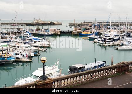 Ramsgate, UK - Nov 26 2020 Yatchs ormeggiato a Ramsgate Royal Harbour. Si possono vedere anche le porte del porto, la fine del ristorante molo e il faro Foto Stock