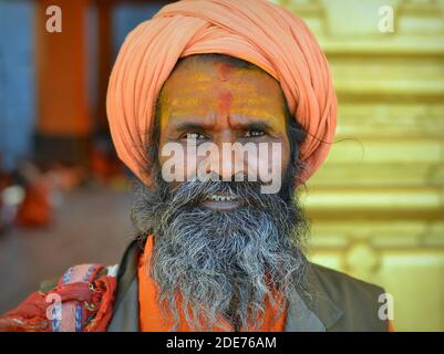 Anziano indiano uomo santo indù (sadhu, baba, guru) con un tripundra giallo dipinto sulla sua fronte posa per la macchina fotografica durante il festival Shivratri Mela. Foto Stock