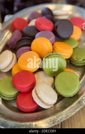 Un vassoio di macaroni colorati. Un macaroon è una piccola torta o un biscotto, tipicamente fatto da mandorle macinate (l'ingrediente principale originale), cocco o oth Foto Stock