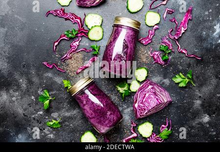 Smoothies disintossicazione sano e utile o succo di cavolo rosso, cetrioli con semi di chia in bottiglie di vetro su uno sfondo grigio, vista dall'alto Foto Stock