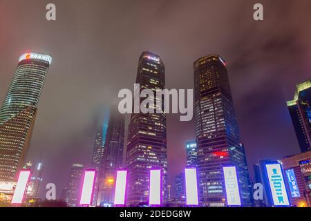 Vista notturna dei grattacieli nel nuovo quartiere di Pudong a Shanghai in un giorno nuvoloso dopo aver piovoso con luce dorata a Shanghai, Cina Foto Stock