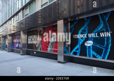 Pfizer World Headquarters Building con striscioni positivi lungo il marciapiede A New York Foto Stock