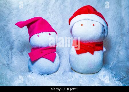 Bambole Snowman realizzate con calzini per festeggiare il Natale. Attività divertenti con i bambini a casa. Riciclare i vecchi calzini. Foto Stock